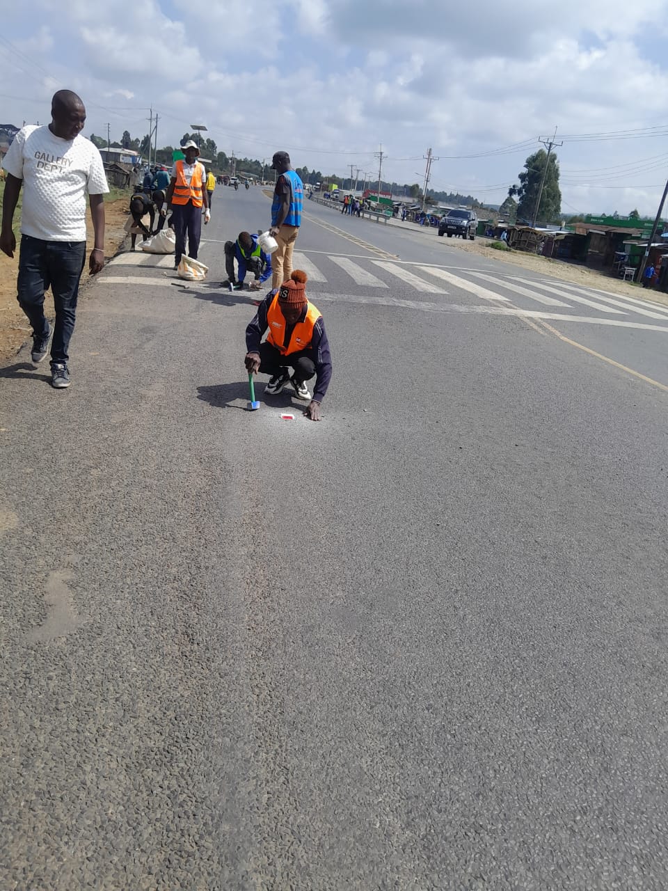 Fixing reflective cat's eyes road studs on asphalt road